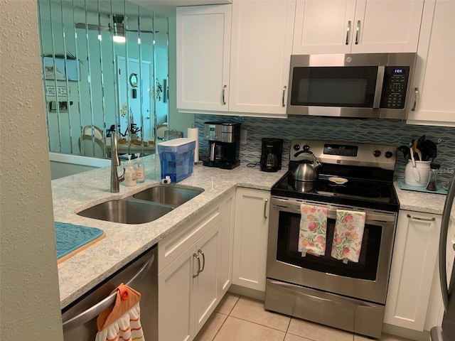 kitchen with white cabinetry, sink, and stainless steel appliances