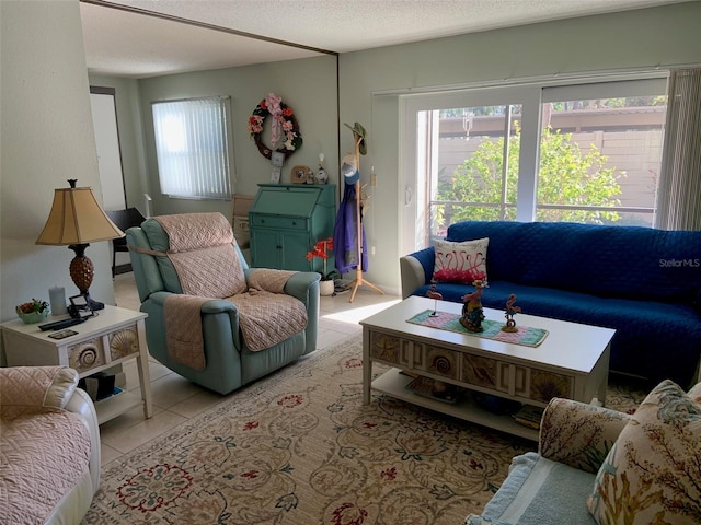 tiled living room featuring plenty of natural light and a textured ceiling