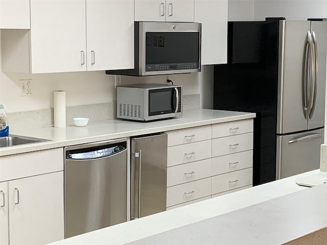 kitchen featuring appliances with stainless steel finishes and white cabinets