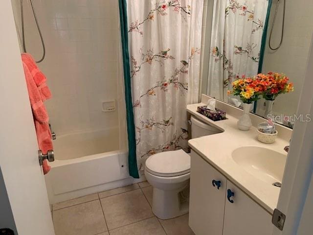 bathroom featuring vanity, tile patterned flooring, toilet, and shower / tub combo with curtain