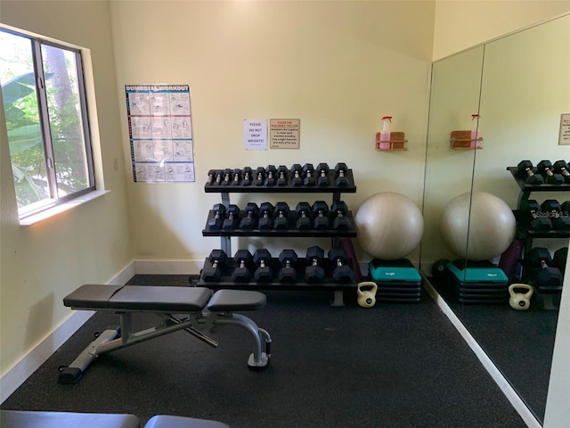 workout room featuring baseboards