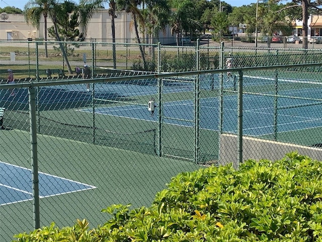 view of sport court featuring fence