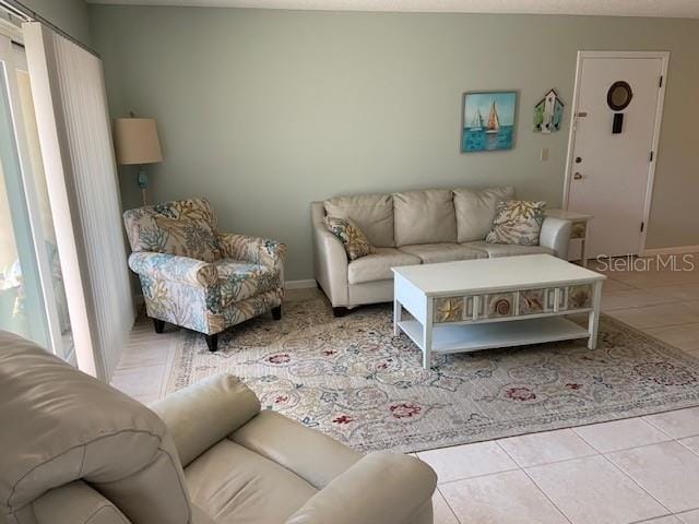 tiled living area featuring baseboards