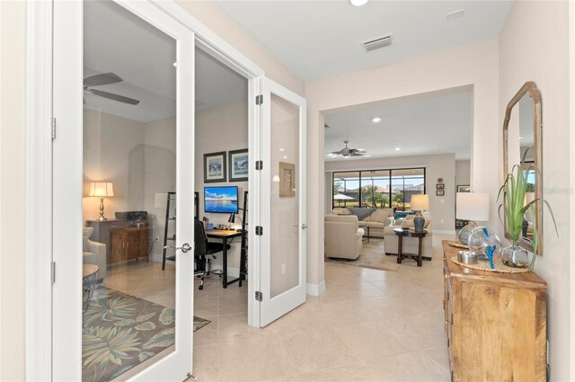 corridor featuring light tile patterned floors and french doors