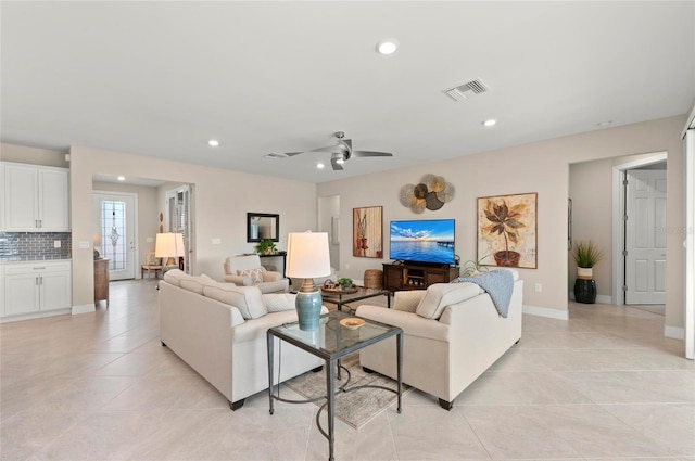 living room with ceiling fan and light tile patterned floors