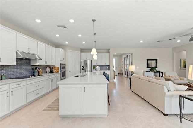 kitchen featuring pendant lighting, sink, white cabinetry, a kitchen island with sink, and stainless steel appliances