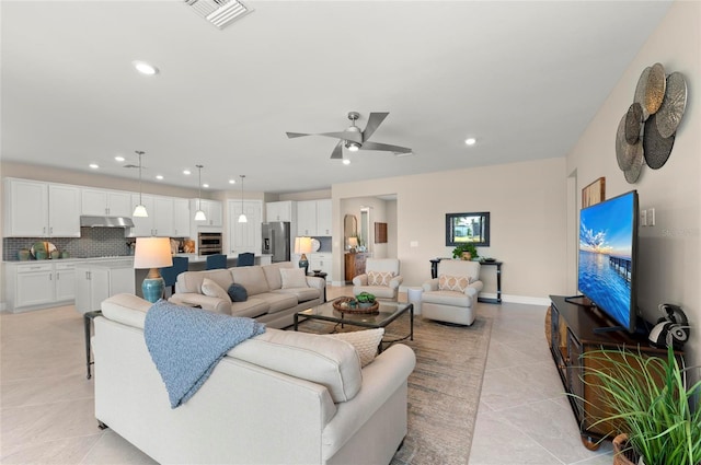 living room featuring light tile patterned floors and ceiling fan