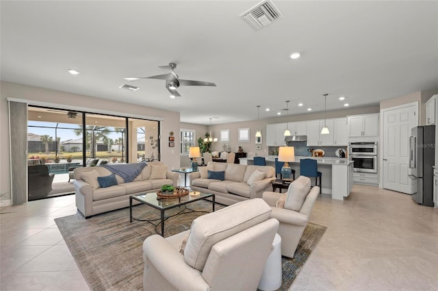 tiled living room with ceiling fan