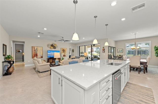 kitchen featuring sink, white cabinets, and decorative light fixtures