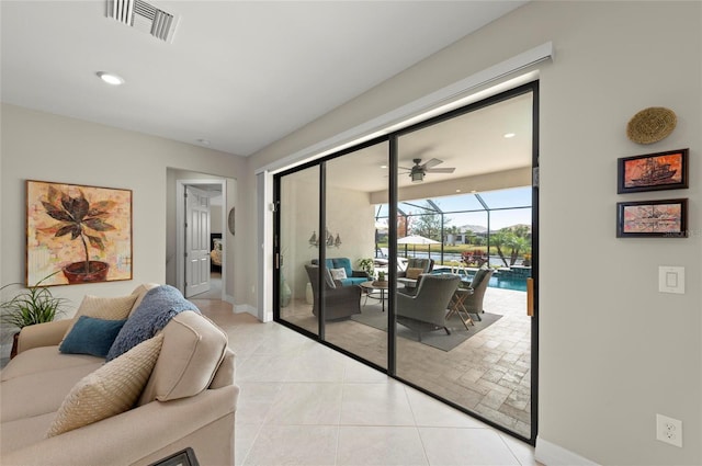 doorway with light tile patterned floors and ceiling fan