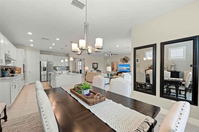 dining room featuring sink and a notable chandelier