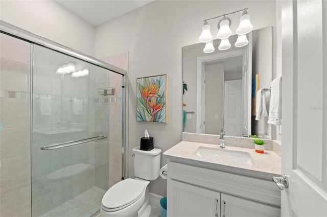 bathroom with vanity, toilet, and an enclosed shower