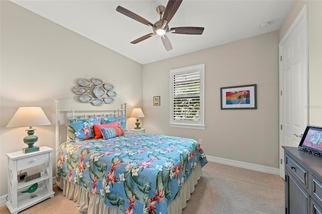 bedroom featuring ceiling fan and light carpet