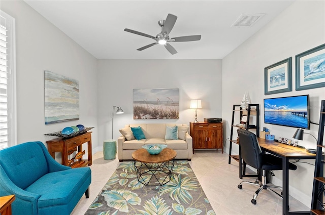 tiled office featuring ceiling fan