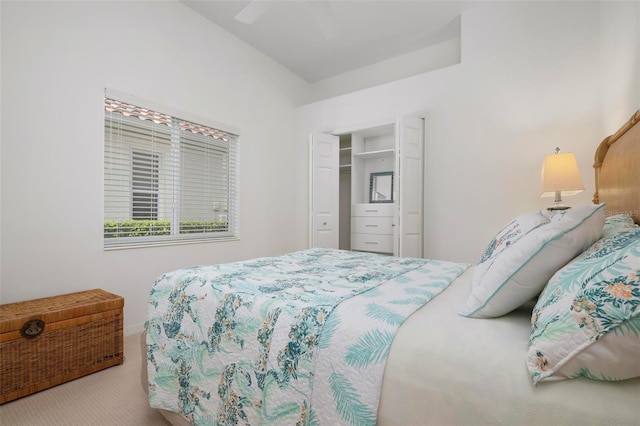 bedroom featuring light colored carpet, ceiling fan, and a closet