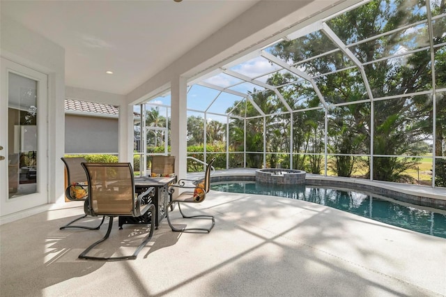 view of pool featuring an in ground hot tub, a patio area, and glass enclosure