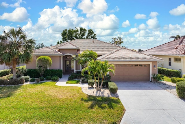 mediterranean / spanish-style house with a garage and a front yard