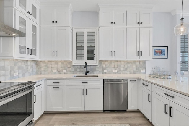 kitchen with appliances with stainless steel finishes, sink, and white cabinets