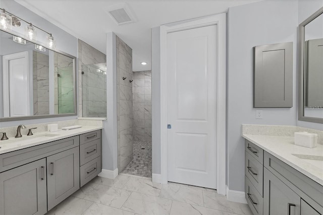 bathroom featuring vanity and tiled shower