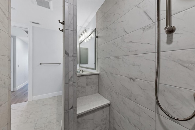 bathroom featuring tiled shower