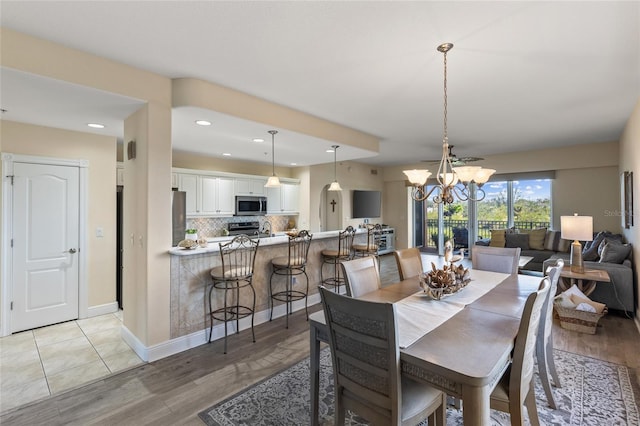 dining area featuring a chandelier and light hardwood / wood-style flooring