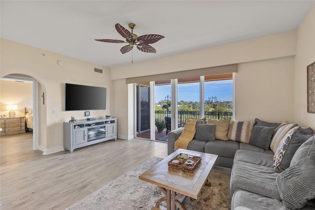 living room featuring ceiling fan and light hardwood / wood-style floors