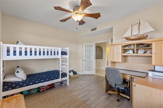 bedroom featuring french doors and light hardwood / wood-style flooring