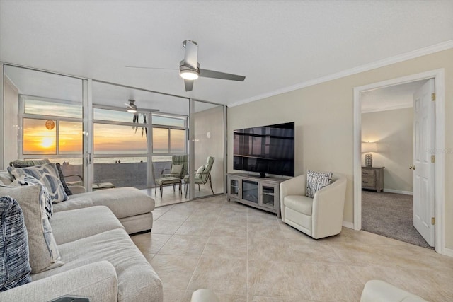 tiled living room with crown molding and ceiling fan