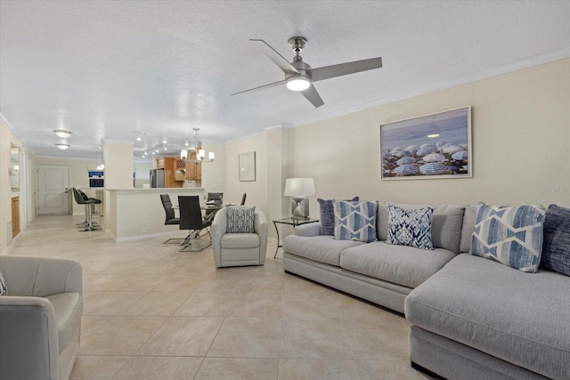 tiled living room with crown molding, ceiling fan with notable chandelier, and a textured ceiling