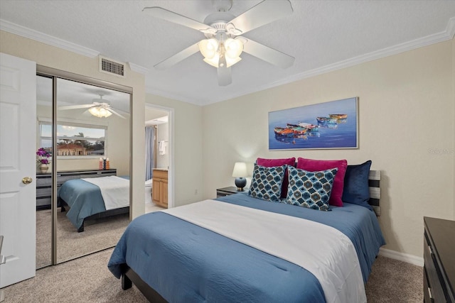 carpeted bedroom featuring crown molding, a textured ceiling, ceiling fan, and a closet