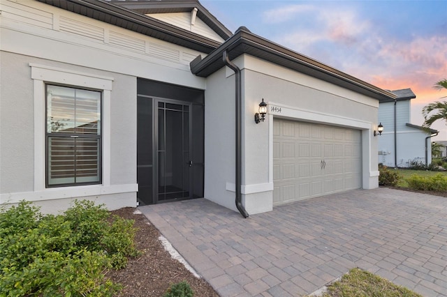 exterior entry at dusk with a garage