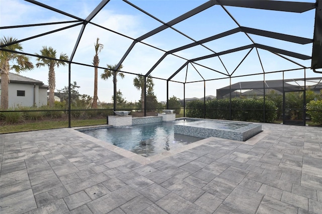 view of swimming pool with an in ground hot tub, pool water feature, glass enclosure, and a patio