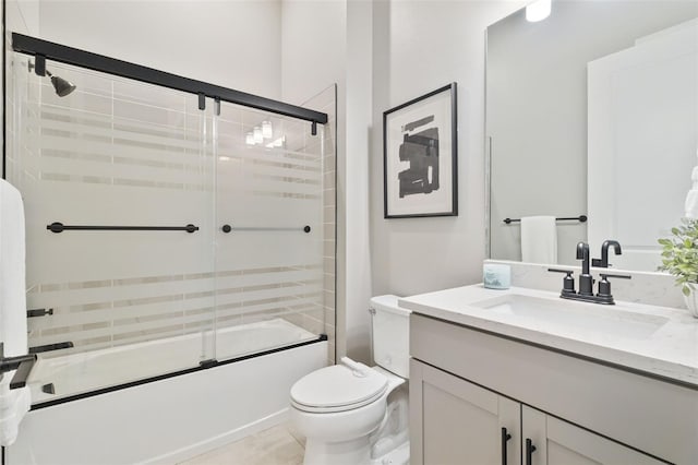 full bathroom featuring toilet, vanity, bath / shower combo with glass door, and tile patterned flooring