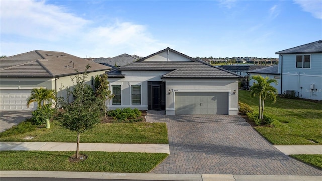 view of front of property featuring a garage and a front lawn