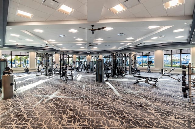 workout area featuring ceiling fan, plenty of natural light, and carpet flooring