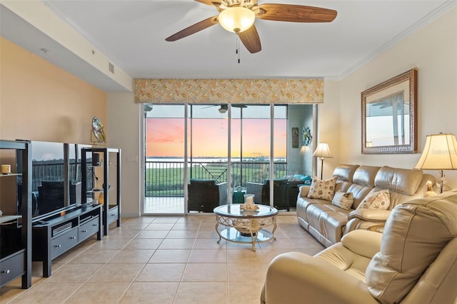 living room featuring light tile patterned floors, crown molding, and ceiling fan