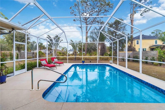 view of swimming pool featuring a lanai and a patio area