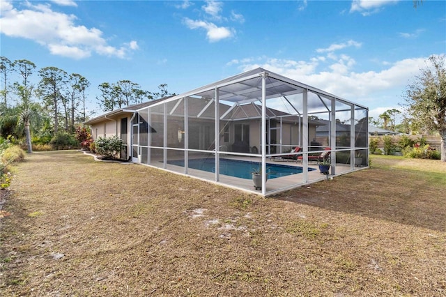 view of pool with a yard and a lanai