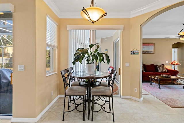 dining area with ornamental molding, light tile patterned floors, and ceiling fan