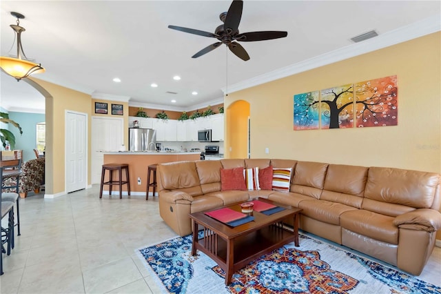 living room with ceiling fan, ornamental molding, and light tile patterned floors