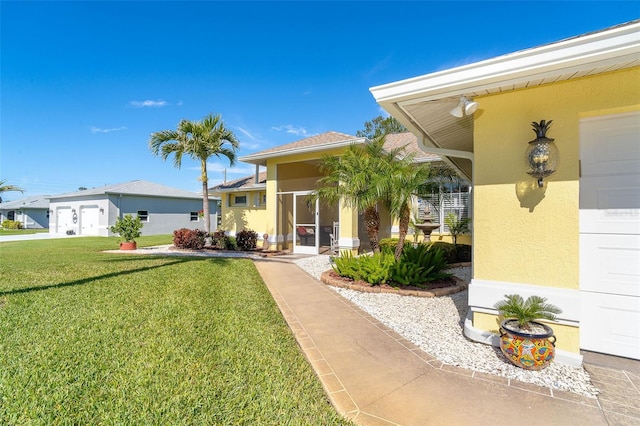 view of front facade with a sunroom and a front yard