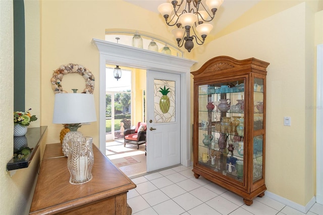 tiled entryway with an inviting chandelier