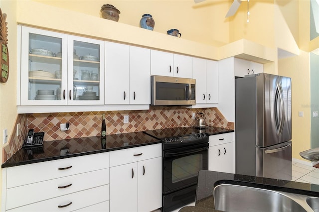 kitchen with tasteful backsplash, ceiling fan, stainless steel appliances, and white cabinets