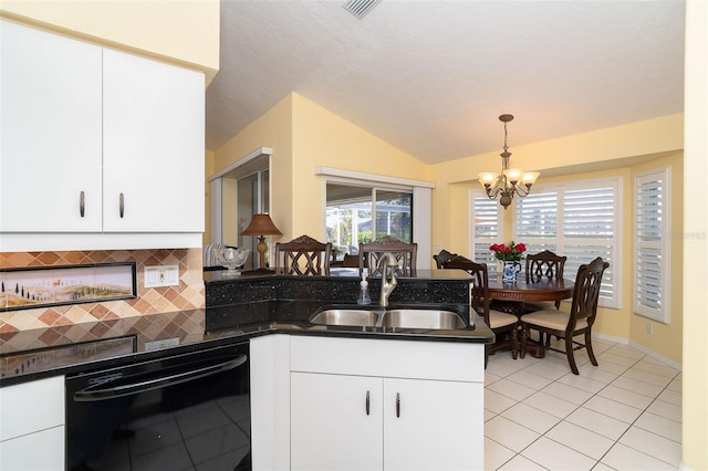 kitchen featuring tasteful backsplash, dishwasher, sink, white cabinets, and hanging light fixtures