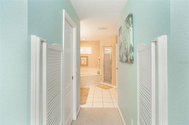 corridor featuring light tile patterned floors