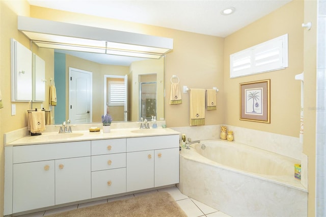 bathroom featuring tile patterned flooring, vanity, and separate shower and tub