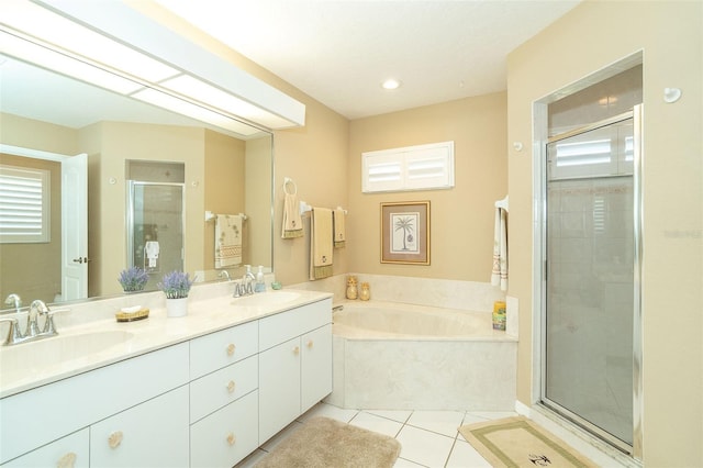 bathroom featuring independent shower and bath, vanity, a healthy amount of sunlight, and tile patterned floors