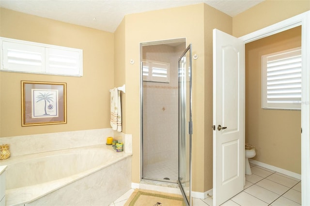 bathroom featuring tile patterned flooring, independent shower and bath, and toilet