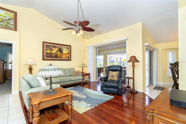 living room featuring wood-type flooring, lofted ceiling, and ceiling fan