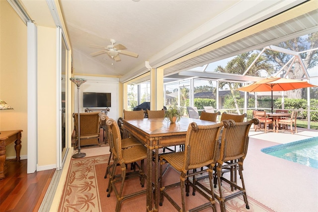 dining area featuring hardwood / wood-style flooring, ceiling fan, and lofted ceiling